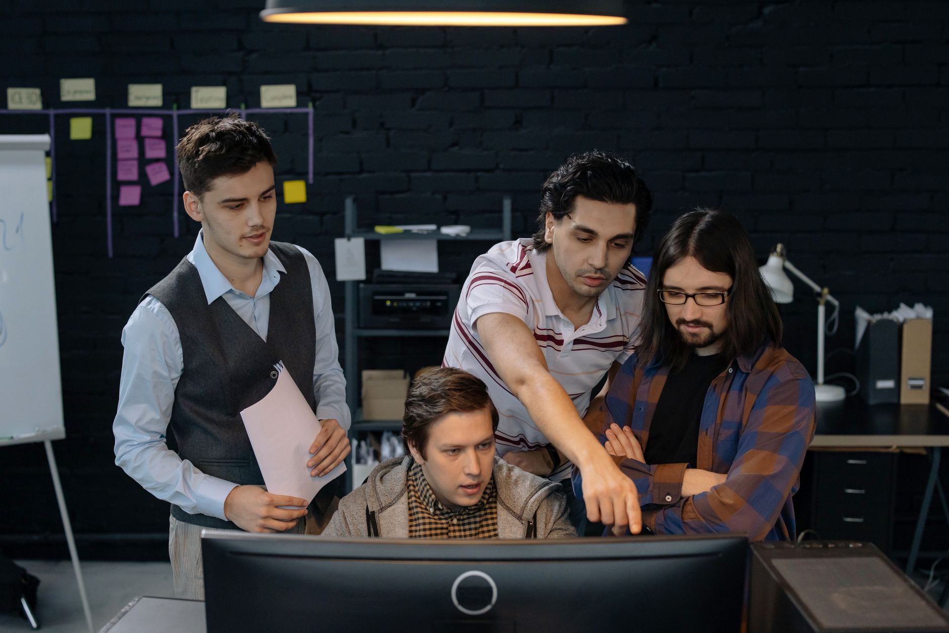 Developers and legal counsel reviewing AI model design on a whiteboard